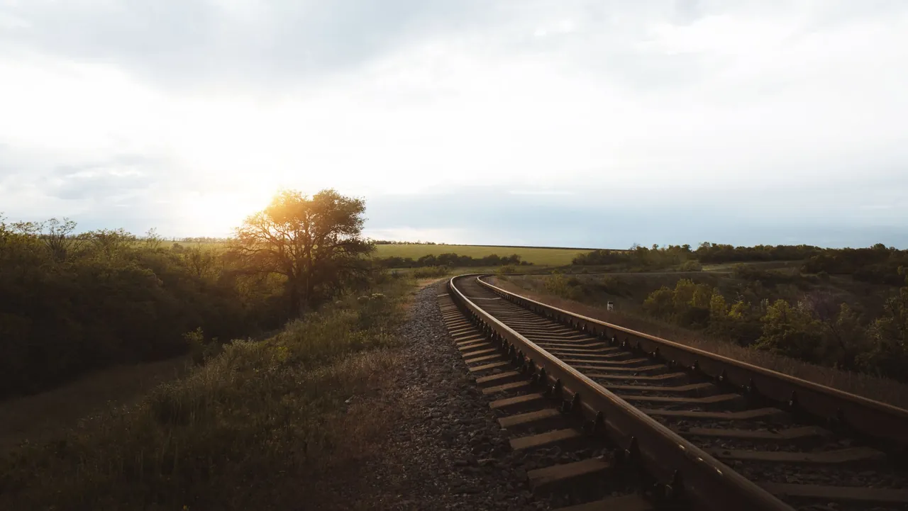 Railway track through open countryside in low evening sun, a location from one of our shoots