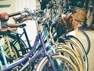 A row of colourful bicycles with baskets