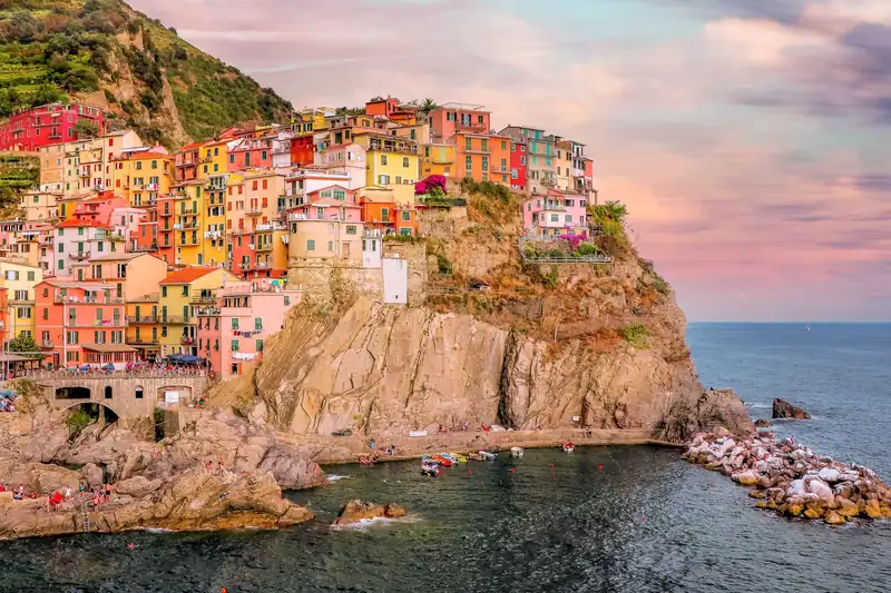 Colourful houses stacked on a cliff above the sea
