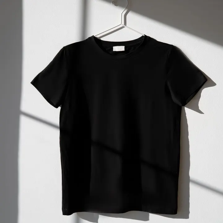 Plain black T-shirt on a hanger