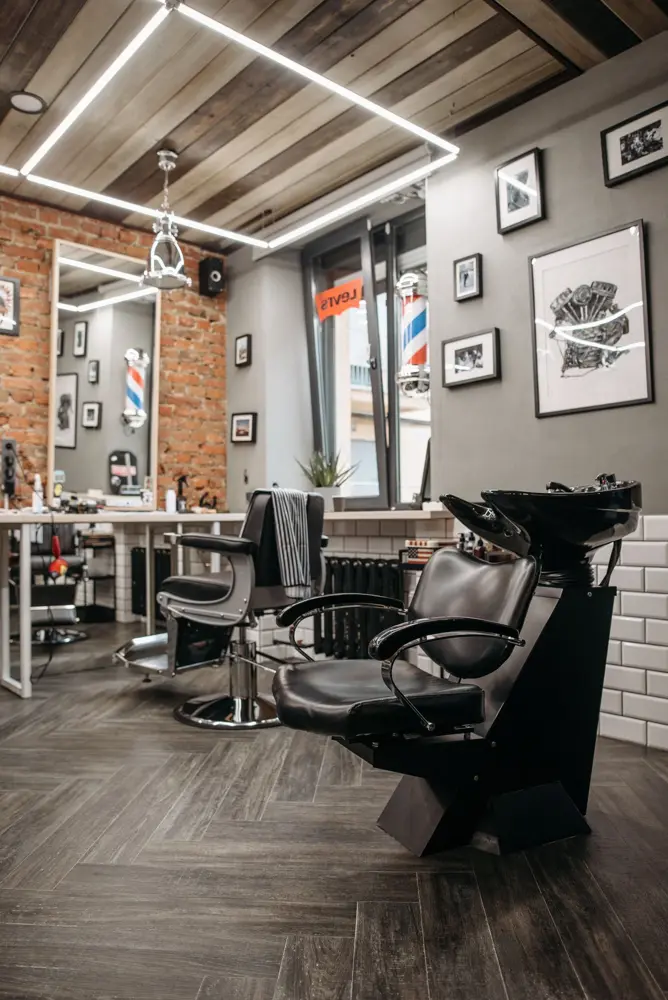 Barber shop interior with leather chairs, mirrors and framed pictures