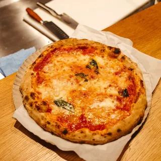 A margherita pizza on a wooden board