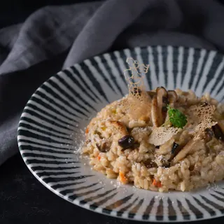 Mushroom risotto on a striped plate